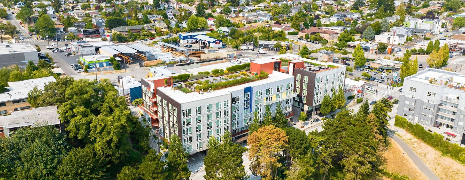 a group of buildings with trees in front of them