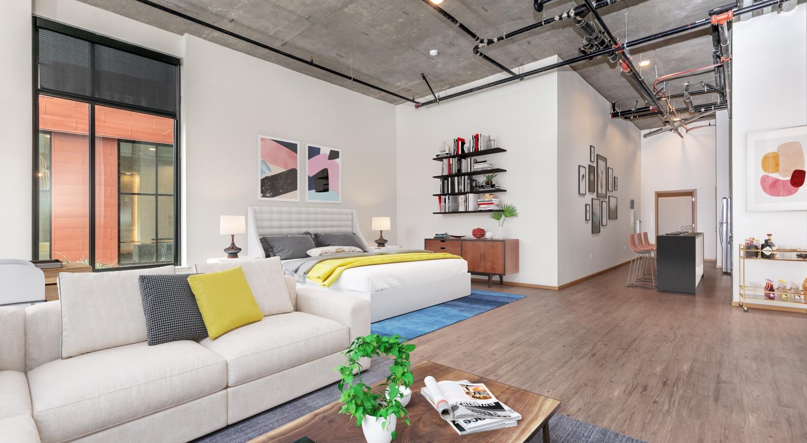 Relax and unwind in well-lit living areas a room with a couch and a table with a book on it